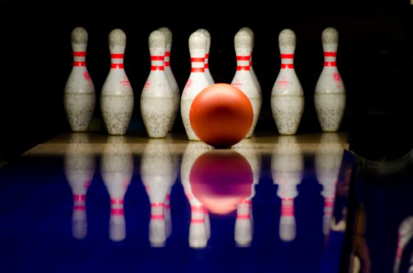 Bowling Ball on Lane Near Bowling Pins