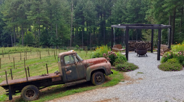 Bench swings by the fire pit at Sweet Acre Farms